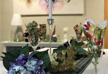 Nyårsdukning på med servetter i glas, vackra blommor och tända ljus