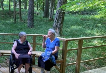 Två kvinnor samtalar i skogen
